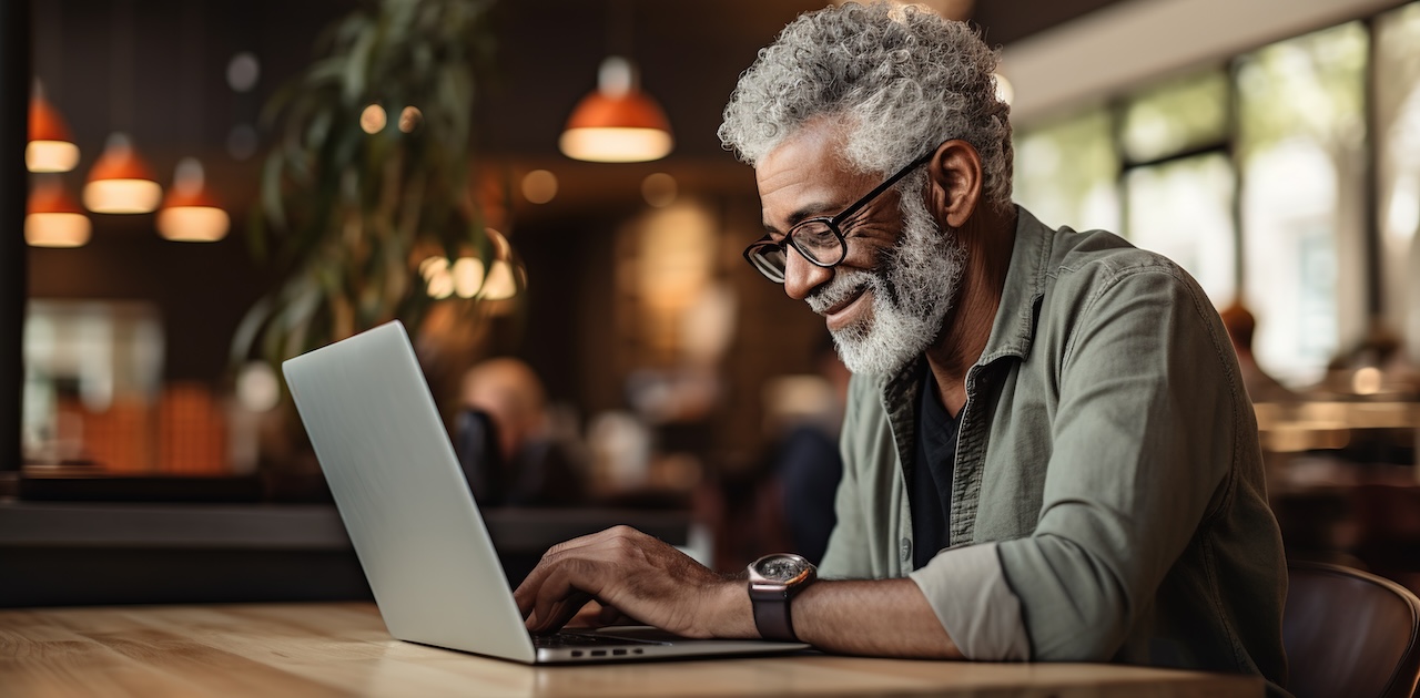 A man sitting at a computer playing bunco against AI-generated players.