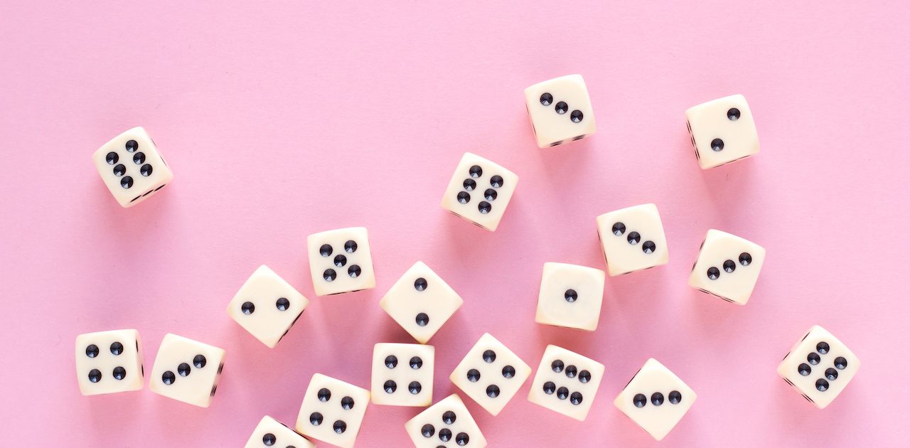 Dice on a pink background.