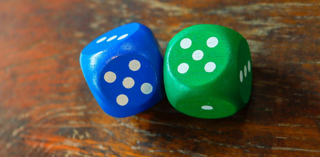 A pair of dice - one is green, the other is blue.